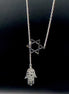 Star of David and Hamsa Drop Necklace - Simply Just Deals LLCStar of David and Hamsa Drop NecklaceJewelry Pendant Necklace42560115703831GoldThe Star of David and Hamsa Drop Necklace features a gold plated chain with a Star of David pendant and a delicate filigree Hamsa hand charm, beautifully set against a black background.