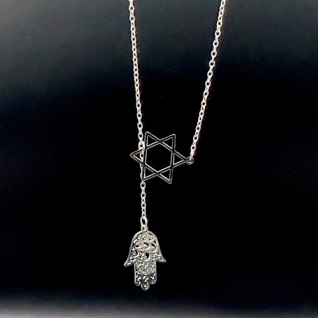 Star of David and Hamsa Drop Necklace - Simply Just Deals LLCStar of David and Hamsa Drop NecklaceJewelry Pendant Necklace42560115703831GoldThe Star of David and Hamsa Drop Necklace features a gold plated chain with a Star of David pendant and a delicate filigree Hamsa hand charm, beautifully set against a black background.