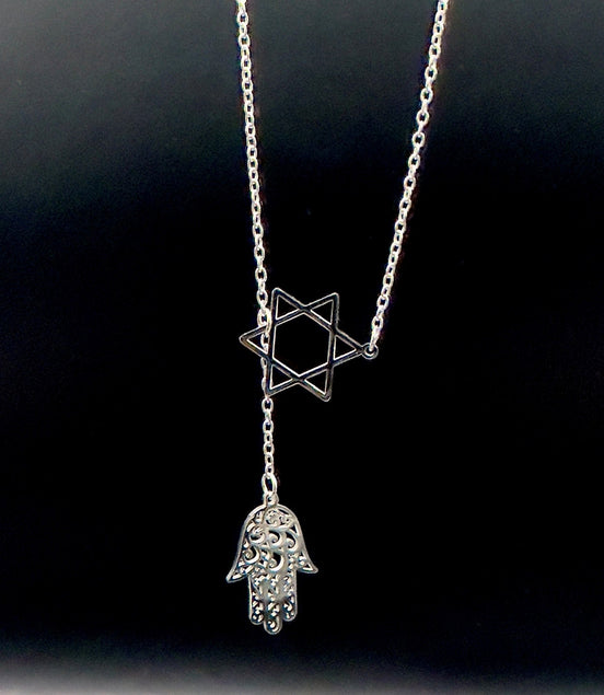 Star of David and Hamsa Drop Necklace - Simply Just Deals LLCStar of David and Hamsa Drop NecklaceJewelry Pendant Necklace42560115703831GoldThe Star of David and Hamsa Drop Necklace features a gold plated chain with a Star of David pendant and a delicate filigree Hamsa hand charm, beautifully set against a black background.
